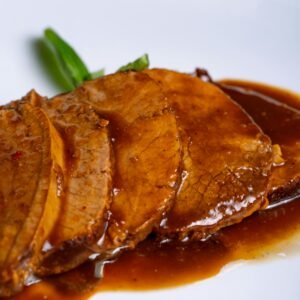 Tender slices of roast beef in rich gravy, a perfect main dish.