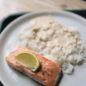 Savor a plate of salmon fillet with creamy rice and a hint of lime.
